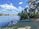 Backyard with waterfront access, featuring a dock, a kayak, and lush greenery for outdoor enjoyment at 1155 7Th N St, Safety Harbor, FL 34695