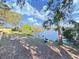 Lush backyard with direct waterfront access, featuring a dock, and a kayak at 1155 7Th N St, Safety Harbor, FL 34695