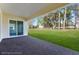 View of an outdoor covered brick porch with a backyard at 4638 Southern Valley Loop, Brooksville, FL 34601