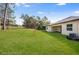 Spacious backyard featuring lush green grass and a partially obstructed view at 4638 Southern Valley Loop, Brooksville, FL 34601