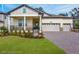 Charming home featuring a manicured lawn, covered porch, and a three-car garage at 4638 Southern Valley Loop, Brooksville, FL 34601