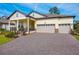 Beautiful home featuring a manicured lawn, covered porch, and a three-car garage at 4638 Southern Valley Loop, Brooksville, FL 34601