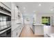 Modern kitchen with stainless steel appliances, white cabinetry and subway tile backsplash at 4638 Southern Valley Loop, Brooksville, FL 34601