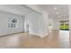 Open-concept living room with wood-look tile floors, large window, and sliding glass doors to the backyard at 4638 Southern Valley Loop, Brooksville, FL 34601