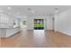 Bright open plan living room and kitchen with access to outdoor space through a sliding glass door at 4638 Southern Valley Loop, Brooksville, FL 34601