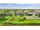 Expansive aerial view highlighting the property's private backyard, manicured lawn, and tranquil water views at 7127 Forest Mere Dr, Riverview, FL 33578