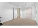 Neutral bedroom featuring wainscoting, carpet flooring, and a doorway into another room at 7127 Forest Mere Dr, Riverview, FL 33578