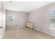 Neutral bedroom featuring carpet flooring and two windows, providing ample light and a cozy atmosphere at 7127 Forest Mere Dr, Riverview, FL 33578