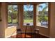 Cozy breakfast nook with scenic backyard view, hardwood floors, and stylish barstools at 7127 Forest Mere Dr, Riverview, FL 33578