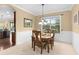 Formal dining room featuring classic furniture and large window for ample natural light at 7127 Forest Mere Dr, Riverview, FL 33578