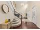 Bright foyer boasts a chandelier, hardwood floors, and a staircase with white railings at 7127 Forest Mere Dr, Riverview, FL 33578