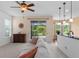 Bright and airy living room with sliding doors to the outdoor space and open to the kitchen at 7127 Forest Mere Dr, Riverview, FL 33578