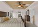 Spacious main bedroom featuring a ceiling fan and decorative ceiling trim, creating a comfortable and luxurious ambiance at 7127 Forest Mere Dr, Riverview, FL 33578