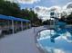 Community pool area with ample seating and a fun water slide at 7127 Forest Mere Dr, Riverview, FL 33578