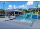 Community pool featuring a water slide and various lounge chairs for residents' enjoyment at 7127 Forest Mere Dr, Riverview, FL 33578