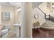 Half bathroom features a pedestal sink, decorative mirror, and tiled flooring at 7127 Forest Mere Dr, Riverview, FL 33578