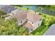 Aerial view of the home's rear elevation, overlooking lush lawns and a lake at 7127 Forest Mere Dr, Riverview, FL 33578