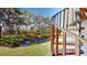 Spiral staircase access to backyard patio overlooking pond at 9550 Tara Cay Ct # 17, Seminole, FL 33776