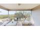 Screened balcony with outdoor furniture and scenic views at 9550 Tara Cay Ct # 17, Seminole, FL 33776