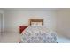 Cozy bedroom with tiled floors, a rustic bed frame, and blue bedding at 9550 Tara Cay Ct # 17, Seminole, FL 33776