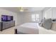 Spacious bedroom with large bed and TV at 9550 Tara Cay Ct # 17, Seminole, FL 33776