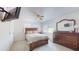 Bright bedroom with double bed, dresser, and ceiling fan at 9550 Tara Cay Ct # 17, Seminole, FL 33776