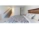 Main bedroom with a wooden staircase and a bed with blue bedding at 9550 Tara Cay Ct # 17, Seminole, FL 33776