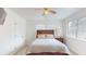 Well-lit bedroom featuring a bed, nightstand, and ceiling fan at 9550 Tara Cay Ct # 17, Seminole, FL 33776