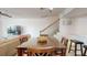 Bright dining area with wood table and chairs, adjacent to stairs at 9550 Tara Cay Ct # 17, Seminole, FL 33776