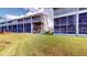 Building exterior showcasing multiple units and screened patios at 9550 Tara Cay Ct # 17, Seminole, FL 33776