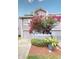 Townhome exterior featuring a garage and flowering plants at 9550 Tara Cay Ct # 17, Seminole, FL 33776