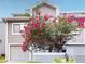 Two-story townhome with attached garage and vibrant landscaping at 9550 Tara Cay Ct # 17, Seminole, FL 33776