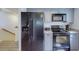 Modern kitchen with black appliances and gray cabinets at 9550 Tara Cay Ct # 17, Seminole, FL 33776