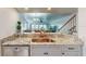 Modern kitchen with granite countertops and stainless steel appliances at 9550 Tara Cay Ct # 17, Seminole, FL 33776
