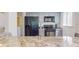 Granite countertop kitchen with black appliances at 9550 Tara Cay Ct # 17, Seminole, FL 33776