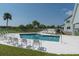 Inviting community pool with chairs for relaxing at 9550 Tara Cay Ct # 17, Seminole, FL 33776