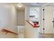 Upstairs hallway with staircase, access to bedrooms, and a view of a bedroom at 9550 Tara Cay Ct # 17, Seminole, FL 33776