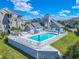 Community pool with lounge chairs and shaded areas at 5722 Biscayne Ct # 203, New Port Richey, FL 34652