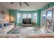 Living room with teal walls, comfy seating and access to balcony at 5722 Biscayne Ct # 203, New Port Richey, FL 34652
