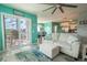 Living room with teal walls, comfy seating and access to balcony at 5722 Biscayne Ct # 203, New Port Richey, FL 34652