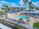 Relaxing community pool with lounge chairs and palm trees at 5722 Biscayne Ct # 203, New Port Richey, FL 34652