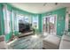 Living room with teal walls, comfy seating and access to balcony at 5722 Biscayne Ct # 203, New Port Richey, FL 34652