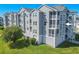 Gray multi-story building with balconies and exterior stairs at 5722 Biscayne Ct # 203, New Port Richey, FL 34652