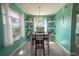 Dining room with table and chairs, featuring built-in shelving at 5722 Biscayne Ct # 203, New Port Richey, FL 34652