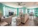 Bright living room with light colored sofas and large TV at 5722 Biscayne Ct # 203, New Port Richey, FL 34652