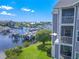 Gray building with balconies overlooking marina; unit highlighted at 5722 Biscayne Ct # 203, New Port Richey, FL 34652