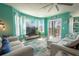 Living room with teal walls, comfy seating and access to balcony at 5722 Biscayne Ct # 203, New Port Richey, FL 34652