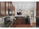 Modern kitchen with granite countertops and dark wood cabinets at 7127 Forest Mere Dr, Riverview, FL 33578