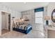 Cozy bedroom with wood-look walls, striped bedding, and en-suite bathroom at 16809 Harvest Moon Way, Bradenton, FL 34211