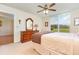 Bright bedroom with double bed, dresser, and view of green space at 3780 Pinebrook Cir # 102, Bradenton, FL 34209